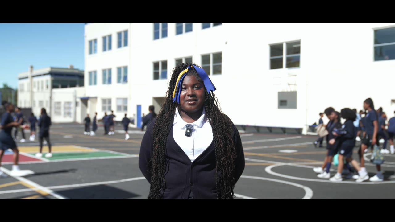 A student stands in a school yard during an education nonprofit's donor film